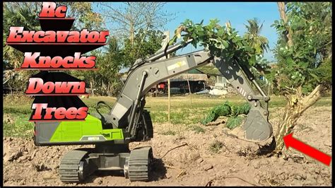 felling a tree with mini excavator|excavator knocks down trees.